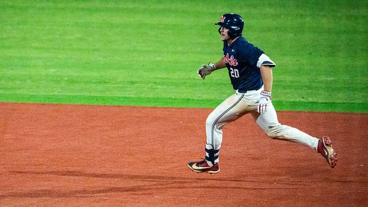Ole Miss catcher Collin Reuter runs for second base during a college baseball game between Mississippi State and Ole Miss.