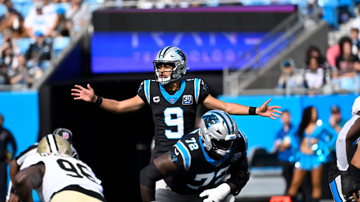 Nov 3, 2024; Charlotte, North Carolina, USA; Carolina Panthers quarterback Bryce Young (9) calls a play as offensive tackle Taylor Moton (72) looks on and New Orleans Saints defensive end Carl Granderson (96) prepares to defend in the first qarter at Bank of America Stadium. Mandatory Credit: Bob Donnan-Imagn Images