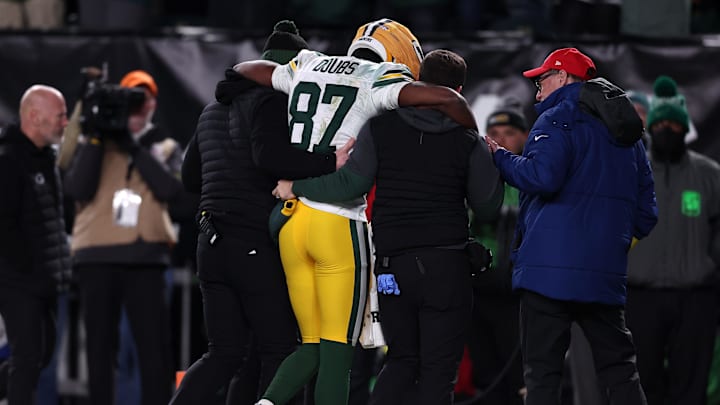 Green Bay Packers wide receiver Romeo Doubs (87) is helped off the field after suffering a concussion against the Eagles.