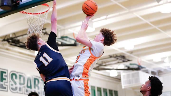 King's Academy senior Claxton Ladine (11) goes up to contest a shot by Xane Machle of Riverside Poly in the second game of the MLK Classic at De La Salle on Monday. 