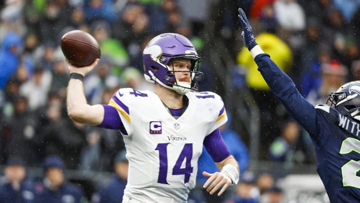 Dec 22, 2024; Seattle, Washington, USA; Minnesota Vikings quarterback Sam Darnold (14) passes against the Seattle Seahawks during the second quarter at Lumen Field. Mandatory Credit: Joe Nicholson-Imagn Images