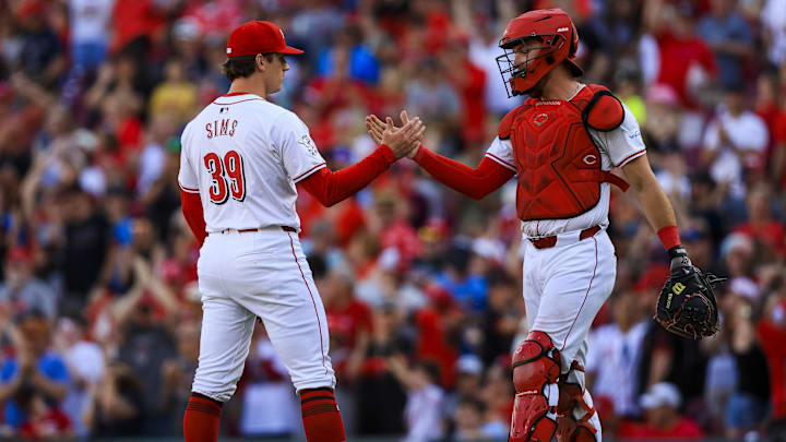May 27, 2024; Cincinnati, Ohio, USA; Cincinnati Reds relief pitcher Lucas Sims (39) shakes hands with catcher Tyler Stephenson (37) after the victory over the St. Louis Cardinals at Great American Ball Park. Mandatory Credit: Katie Stratman-USA TODAY Sports