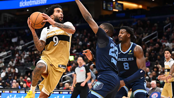 Dec 28, 2025; Washington, District of Columbia, USA; Washington Wizards forward Justin Champagnie (9) shoots over Memphis Grizzlies forward Cedric Coward (23) during the second half at Capital One Arena. Mandatory Credit: Brad Mills-Imagn Images