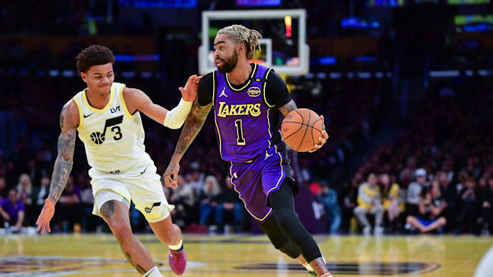Nov 19, 2024; Los Angeles, California, USA;  Los Angeles Lakers guard D’Angelo Russell (1) moves the ball against against Utah Jazz guard Keyonte George (3) during the first half at Crypto.com Arena. Mandatory Credit: Gary A. Vasquez-Imagn Images