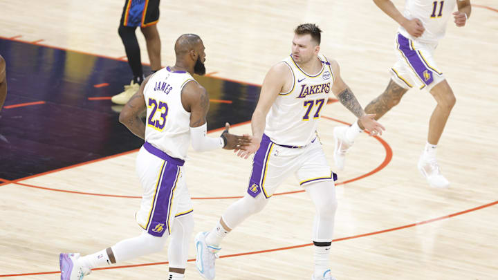 Apr 6, 2025; Oklahoma City, Oklahoma, USA; Los Angeles Lakers guard Luka Doncic (77) and forward LeBron James (23) high five after scoring against the Oklahoma City Thunder during the first quarter at Paycom Center. Mandatory Credit: Alonzo Adams-Imagn Images