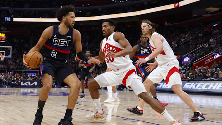 Mar 13, 2024; Detroit, Michigan, USA;  Detroit Pistons guard Cade Cunningham (2) dribbles against  Toronto Raptors guard Ochai Agbaji (30) and forward Kelly Olynyk (41) in the first half at Little Caesars Arena. Mandatory Credit: Rick Osentoski-Imagn Images