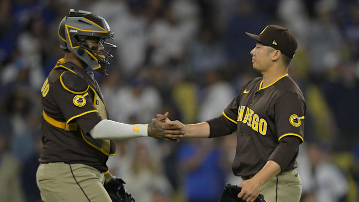 San Diego Padres catcher Martin Maldonado (15) shakes hands with relief pitcher Yuki Matsui (1) reacts after striking out Los Angeles Dodgers catcher Dalton Rushing (68) for the final out of the ninth inning at Dodger Stadium on June 19.