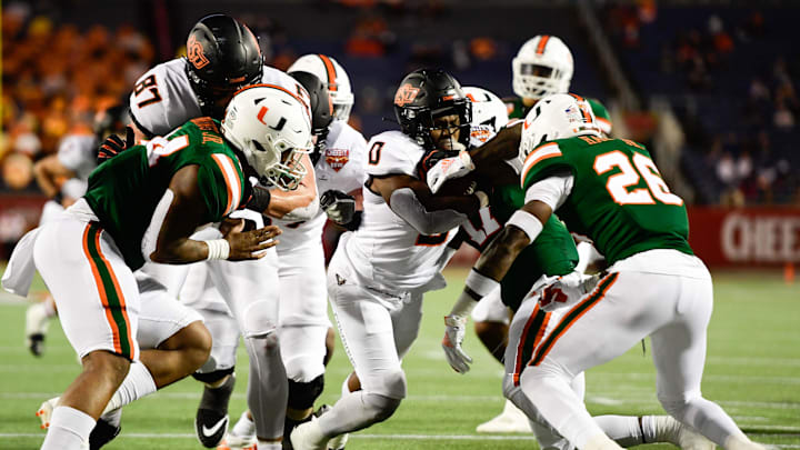 Dec 29, 2020; Orlando, FL, USA; Oklahoma State Cowboys running back LD Brown (0) runs the ball in for a touchdown against the Miami Hurricanes during the first half of the Cheez-It Bowl Game at Camping World Stadium. Mandatory Credit: Douglas DeFelice-USA TODAY Sports