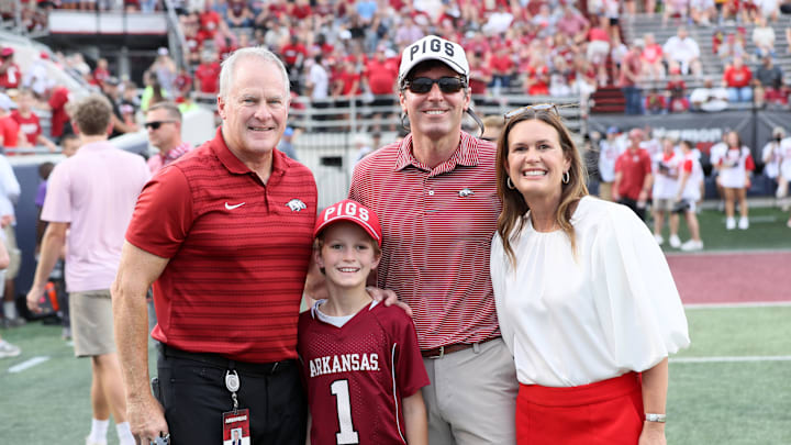 Aug 29, 2024; Little Rock, Arkansas, USA; Arkansas Razorbacks athletic director Hunter Yurachek poses for a photo with Arkansas governor Sarah Huckabee Sanders and her family prior to the game against the Pine Bluff Golden Lions at War Memorial Stadium. Mandatory Credit: Nelson Chenault-Imagn Images