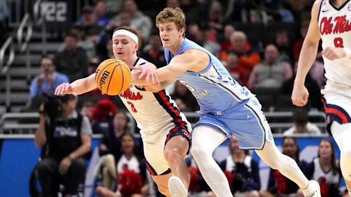 Mar 21, 2025; Milwaukee, WI, USA; Mississippi Rebels guard Sean Pedulla (3) and North Carolina Tar Heels guard Cade Tyson (5) chase a loose ball during the first half of a first round NCAA men’s tournament game at Fiserv Forum. Mandatory Credit: Jeff Hanisch-Imagn Images Mar 21, 2025; Milwaukee, WI, USA; Mississippi Rebels guard Sean Pedulla (3) and North Carolina Tar Heels guard Cade Tyson (5) chase a loose ball during the first half of a first round NCAA men’s tournament game at Fiserv Forum. Mandatory Credit: Jeff Hanisch-Imagn Images