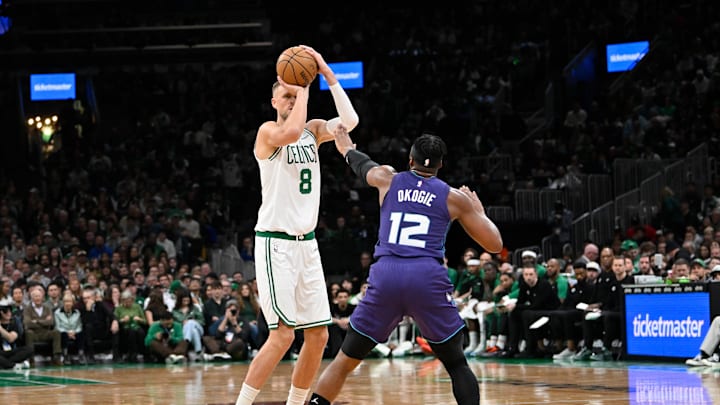 Apr 11, 2025; Boston, Massachusetts, USA; Boston Celtics center Kristaps Porzingis (8) shoots over Charlotte Hornets forward Josh Okogie (12) during the first half at TD Garden. Mandatory Credit: Eric Canha-Imagn Images