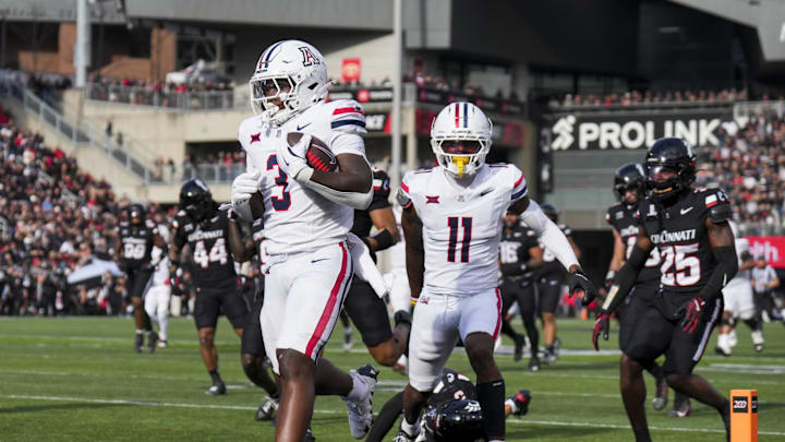 Nov 15, 2025; Cincinnati, Ohio, USA; Arizona Wildcats running back Kedrick Reescano (3) carries the ball for a touchdown against the Cincinnati Bearcats in the second half at Nippert Stadium. Mandatory Credit: Aaron Doster-Imagn Images Nov 15, 2025; Cincinnati, Ohio, USA; Arizona Wildcats running back Kedrick Reescano (3) carries the ball for a touchdown against the Cincinnati Bearcats in the second half at Nippert Stadium. Mandatory Credit: Aaron Doster-Imagn Images