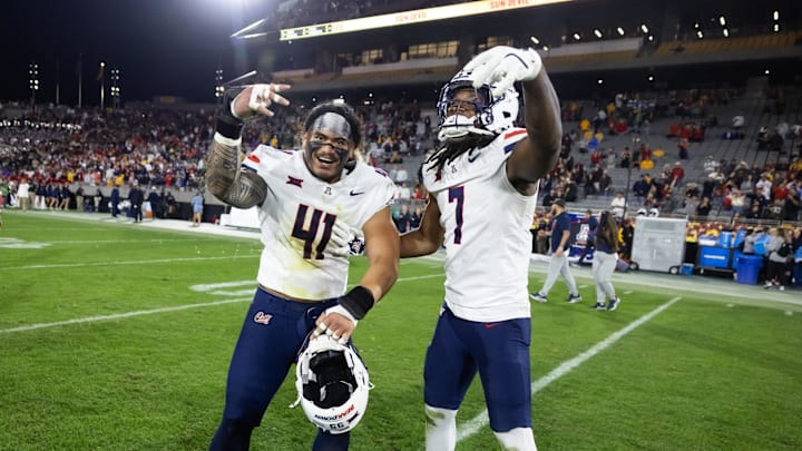 Nov 28, 2025; Tempe, Arizona, USA; Arizona Wildcats defensive lineman Julian Savaiinaea (41) and linebacker Chase Kennedy (7) celebrate after defeating the Arizona State Sun Devils during the 99th Territorial Cup at Mountain America Stadium. Mandatory Credit: Mark J. Rebilas-Imagn Images