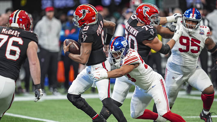 Dec 22, 2024; Atlanta, Georgia, USA; New York Giants linebacker Darius Muasau (53) sacks Atlanta Falcons quarterback Michael Penix Jr. (9) during the first half at Mercedes-Benz Stadium. Mandatory Credit: Dale Zanine-Imagn Images