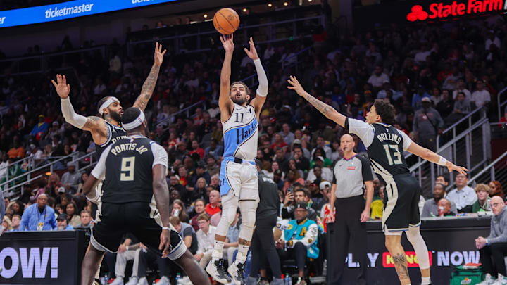 Feb 7, 2025; Atlanta, Georgia, USA; Atlanta Hawks guard Trae Young (11) shoots against the Milwaukee Bucks in the fourth quarter at State Farm Arena. Mandatory Credit: Brett Davis-Imagn Images