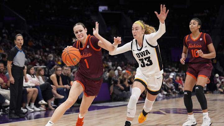 Nov 10, 2024; Charlotte, NC, USA;  Virginia Tech Hokies guard Carleigh Wenzel (1) drives to the basket against Iowa Hawkeyes guard Lucy Olsen (33) during the second half at Spectrum Center. Mandatory Credit: Jim Dedmon-Imagn Images