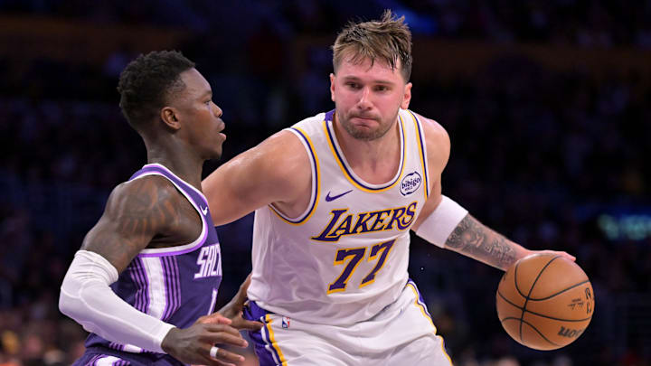 Dec 28, 2025; Los Angeles, California, USA;  Sacramento Kings guard Dennis Schroder (17) defemds Los Angeles Lakers guard Luka Doncic (77) in the second half at Crypto.com Arena. Mandatory Credit: Jayne Kamin-Oncea-Imagn Images