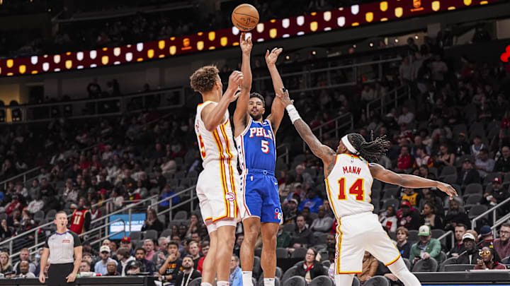 Mar 10, 2025; Atlanta, Georgia, USA; Philadelphia 76ers guard Quentin Grimes (5) shoots against Atlanta Hawks guards Dyson Daniels (5) and Terance Mann (14) during the first half at State Farm Arena. Mandatory Credit: Dale Zanine-Imagn Images