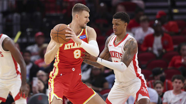 Oct 6, 2025; Houston, Texas, USA; Atlanta Hawks forward/center Kristaps Porzingis (8) controls the ball as Houston Rockets forward Jabari Smith Jr. (10) defends during the first quarter at Toyota Center. Mandatory Credit: Troy Taormina-Imagn Images