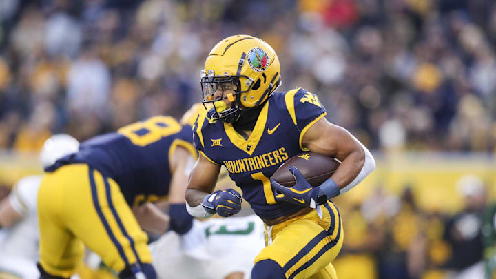 Nov 16, 2024; Morgantown, West Virginia, USA; West Virginia Mountaineers running back Jahiem White (1) runs the ball during the first quarter against the Baylor Bears at Mountaineer Field at Milan Puskar Stadium. Mandatory Credit: Ben Queen-Imagn Images