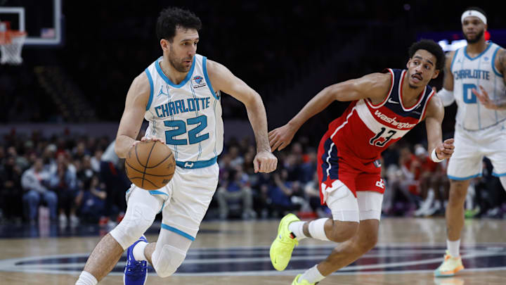 Mar 8, 2024; Washington, District of Columbia, USA; Charlotte Hornets guard Vasa Micic (22) drives to the basket as Washington Wizards guard Jordan Poole (13) defends in the second half at Capital One Arena. Mandatory Credit: Geoff Burke-Imagn Images