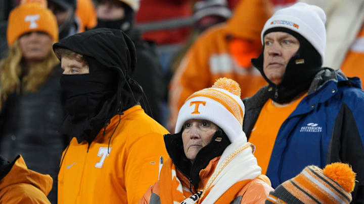 Tennessee fans bundled up to keep warm as they wait for the start of the NCAA college football playoff game between Ohio State and Tennessee on Saturday, Dec. 21, 2024, in Columbus, Ohio.