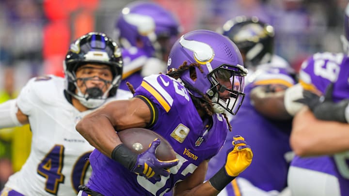 Nov 9, 2025; Minneapolis, Minnesota, USA; Minnesota Vikings running back Aaron Jones Sr. (33) runs with the ball against the Baltimore Ravens in the second quarter at U.S. Bank Stadium. Mandatory Credit: Brad Rempel-Imagn Images