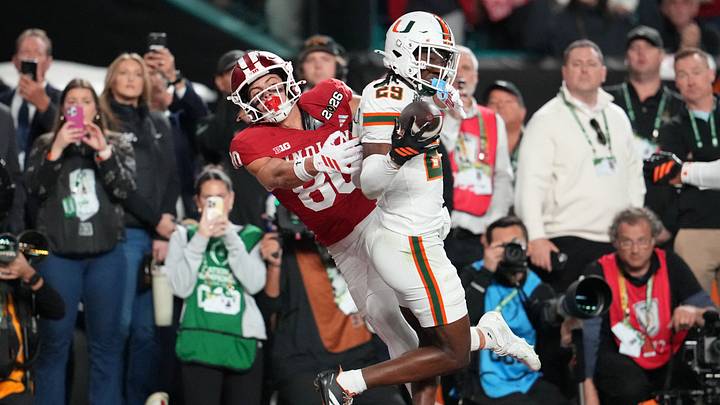 Jan 19, 2026; Miami Gardens, FL, USA; Miami Hurricanes defensive back OJ Frederique Jr. (29) breaks up a pass intended for Indiana Hoosiers wide receiver Charlie Becker (80) during the first half of the College Football Playoff National Championship game at Hard Rock Stadium. Mandatory Credit: Kirby Lee-Imagn Images