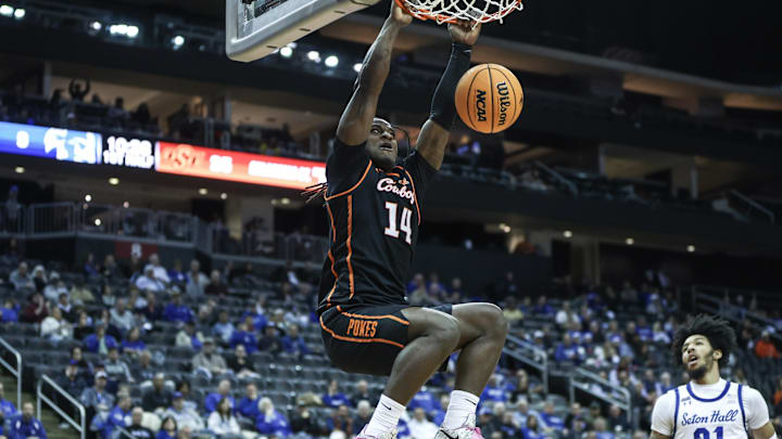 Dec 8, 2024; Newark, New Jersey, USA;  Oklahoma State Cowboys guard Jamyron Keller (14) dunks the ball in the first half against the Seton Hall Pirates at Prudential Center. Mandatory Credit: Wendell Cruz-Imagn Images