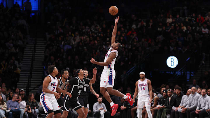 Jan 4, 2025; Brooklyn, New York, USA; Philadelphia 76ers guard Tyrese Maxey (0) leaps for the ball as Brooklyn Nets guard Keon Johnson (45) defends during the second half at Barclays Center. Mandatory Credit: Vincent Carchietta-Imagn Images