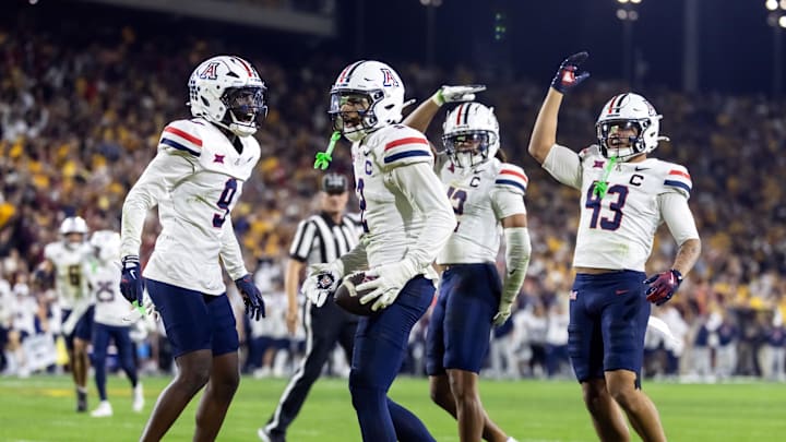 Nov 28, 2025; Tempe, Arizona, USA; Arizona Wildcats defensive back Treydan Stukes (2) celebrates with defensive back Ayden Garnes (9) after an interception against Arizona State Sun Devils in the second half during the 99th Territorial Cup at Mountain America Stadium. Mandatory Credit: Mark J. Rebilas-Imagn Images