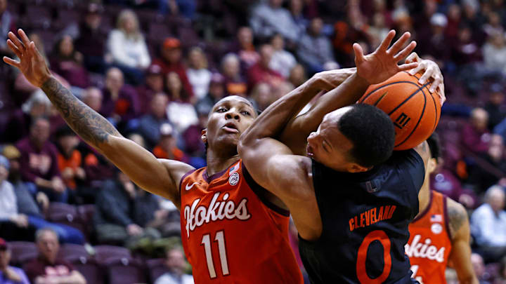 Jan 4, 2025; Blacksburg, Virginia, USA; Virginia Tech Hokies guard Ben Hammond (11) and Miami Hurricanes guard Matthew Cleveland (0) go for the ball during the second half at Cassell Coliseum. Mandatory Credit: Peter Casey-Imagn Images