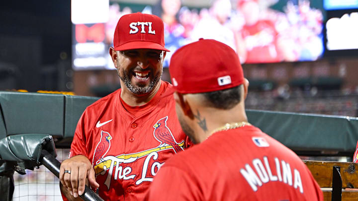 Aug 8, 2025; St. Louis, Missouri, USA;  St. Louis Cardinals manager Oliver Marmol (37) and guest coach Yadier Molina (4) react after right fielder Jordan Walker (not pictured) hit a solo home run against the Chicago Cubs during the sixth inning at Busch Stadium. Mandatory Credit: Jeff Curry-Imagn Images