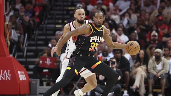 Mar 12, 2025; Houston, Texas, USA; Phoenix Suns forward Kevin Durant (35) controls the ball as Houston Rockets forward Dillon Brooks (9) defends during the third quarter at Toyota Center. Mandatory Credit: Troy Taormina-Imagn Images