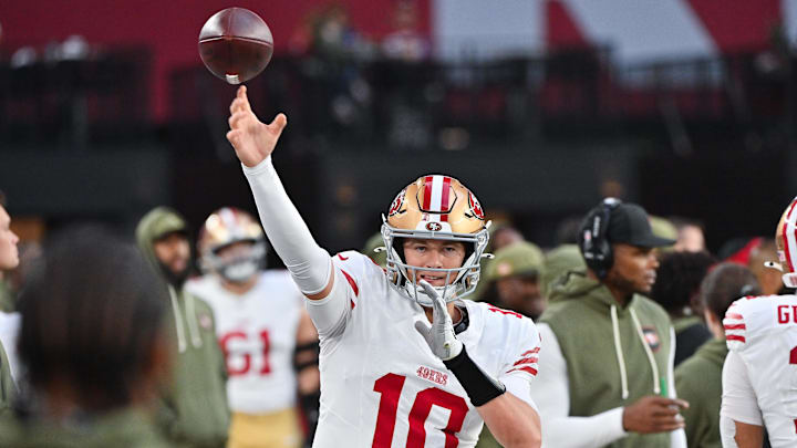 Nov 16, 2025; Glendale, Arizona, USA; San Francisco 49ers quarterback Mac Jones (10) warms up in the second half against the Arizona Cardinals at State Farm Stadium. Mandatory Credit: Matt Kartozian-Imagn Images