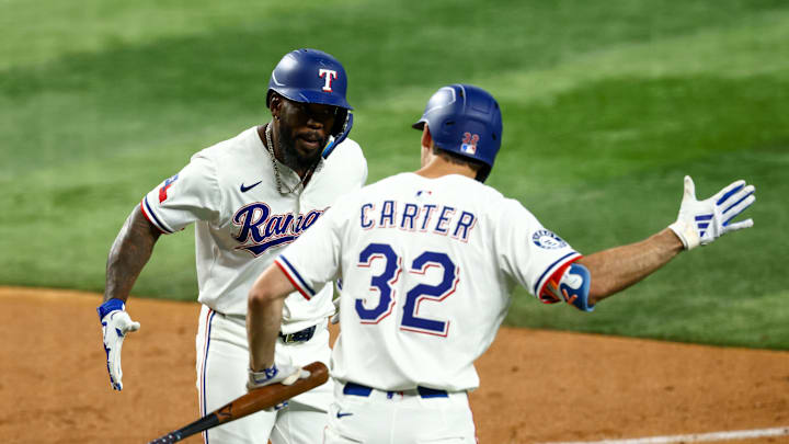 Jul 22, 2025; Arlington, Texas, USA; Texas Rangers right fielder Adolis Garcia (53) celebrates with Texas Rangers center fielder Evan Carter (32) after hitting a home run during the fourth inning against the Athletics at Globe Life Field. Mandatory Credit: Kevin Jairaj-Imagn Images