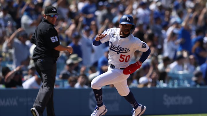 Los Angeles Dodgers shortstop Mookie Betts (50) rounds third and scores during the eighth inning against the New York Mets at Dodger Stadium. 