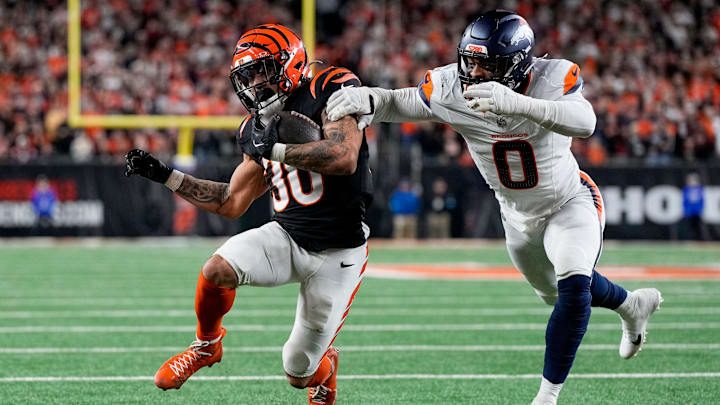 Cincinnati Bengals running back Chase Brown (30) is stopped short of the end zone by Denver Broncos linebacker Jonathon Cooper (0) on a carry in the fourth quarter of the NFL Week 17 game between the Cincinnati Bengals and the Denver Broncos at Paycor Stadium in downtown Cincinnati on Saturday, Dec. 28, 2024. The Bengals took a 30-24 win in overtime to remain in the post season chase.