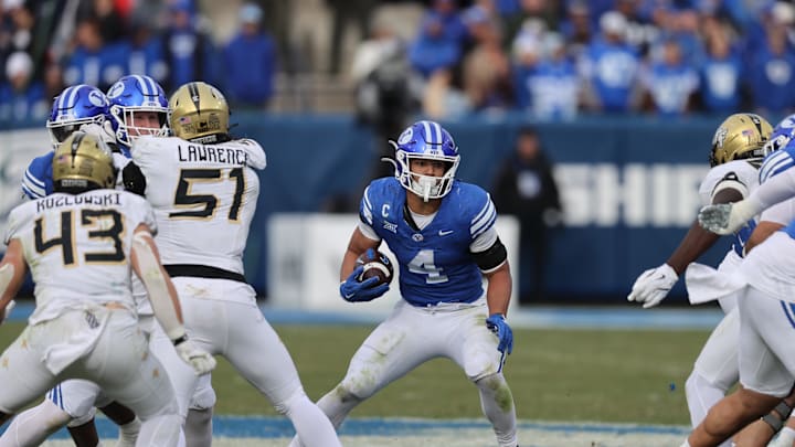 Nov 29, 2025; Provo, Utah, USA; BYU Cougars running back LJ Martin (4) runs the ball against the UCF Knights during the second half at LaVell Edwards Stadium. Mandatory Credit: Rob Gray-Imagn Images