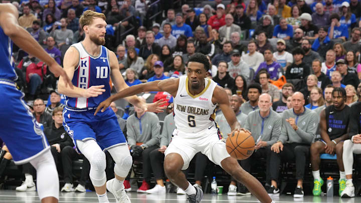 Dec 4, 2023; Sacramento, California, USA; New Orleans Pelicans forward Herbert Jones (5) dribbles against Sacramento Kings forward Domantas Sabonis (10) during the second quarter at Golden 1 Center. Mandatory Credit: Darren Yamashita-Imagn Images