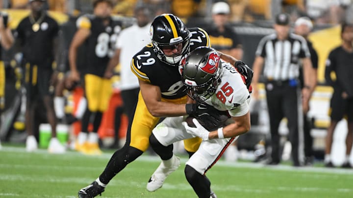 Aug 16, 2025; Pittsburgh, Pennsylvania, USA; Pittsburgh Steelers safety Sebastian Castro (29) tackles Tampa Bay Buccaneers wide receiver Garrett Greene (85) during the second half at Acrisure Stadium. Mandatory Credit: Barry Reeger-Imagn Images