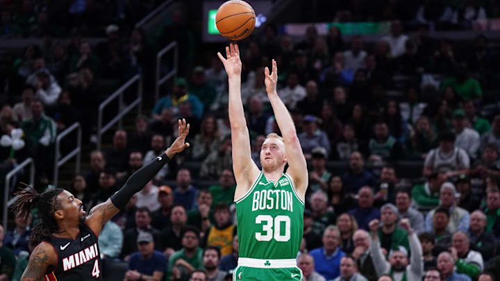 Apr 24, 2024; Boston, Massachusetts, USA; Boston Celtics forward Sam Hauser (30) shoots for three points against Miami Heat guard Delon Wright (4) in the second quarter during game two of the first round for the 2024 NBA playoffs at TD Garden. Mandatory Credit: David Butler II-Imagn Images