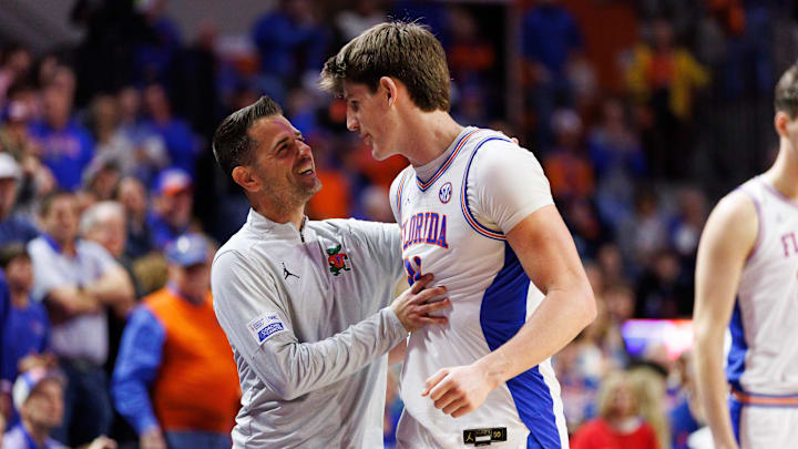 Feb 1, 2026; Gainesville, Florida, USA; Florida Gators head coach Todd Golden embraces Florida Gators forward Alex Condon (21) against the Alabama Crimson Tide during the second half at Exactech Arena at the Stephen C. O'Connell Center. Mandatory Credit: Matt Pendleton-Imagn Images