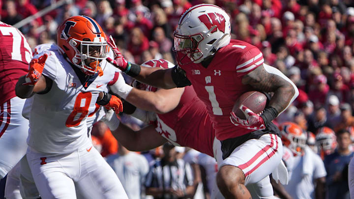 Wisconsin running back Chez Mellusi (1) is tackled by Illinois linebacker Tarique Barnes (8) during the first quarter of their game Saturday, October 1, 2022 at Camp Randall Stadium in Madison, Wis.