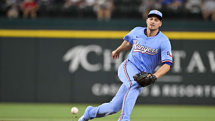 Aug 24, 2025; Arlington, Texas, USA; Texas Rangers shortstop Corey Seager (5) cannot field a ball hit by Cleveland Guardians second baseman Brayan Rocchio (not pictured) during the second inning at Globe Life Field. Mandatory Credit: Jerome Miron-Imagn Images