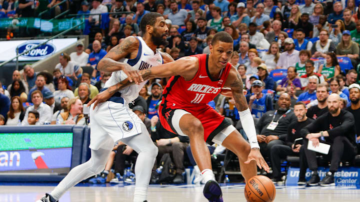 Apr 7, 2024; Dallas, Texas, USA; Houston Rockets forward Jabari Smith Jr. (10) drives around Dallas Mavericks guard Kyrie Irving (11) during the third quarter at American Airlines Center. Mandatory Credit: Andrew Dieb-Imagn Images