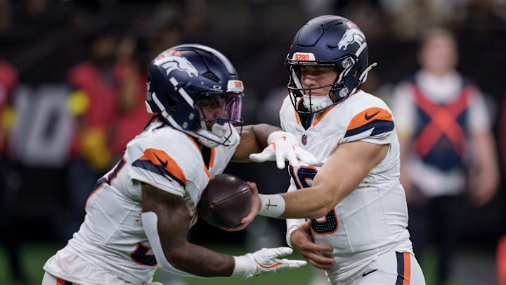 Aug 23, 2025; New Orleans, Louisiana, USA;  Denver Broncos quarterback Bo Nix (10) hands off to Denver Broncos running back RJ Harvey (37) against the New Orleans Saints during the first half at Caesars Superdome. 