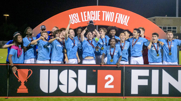 The Seacoast United Phantoms raise their trophy after defeating Peoria City 3-2 in overtime of the USL2 national championship match Saturday, Aug. 3, 2024 at Shea Stadium in Peoria.