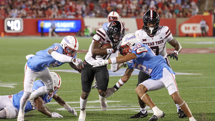 Oct 4, 2025; Houston, Texas, USA; Texas Tech Red Raiders running back J'Koby Williams (20) rushes against Houston Cougars defensive back Marc Stampley II (22) in the second half at TDECU Stadium. Mandatory Credit: Thomas Shea-Imagn Images