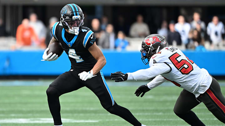 Dec 21, 2025; Charlotte, North Carolina, USA; Carolina Panthers wide receiver Tetairoa McMillan (4) runs against Tampa Bay Buccaneers linebacker Lavonte David (54) during the second half at Bank of America Stadium. Mandatory Credit: Bob Donnan-Imagn Images Dec 21, 2025; Charlotte, North Carolina, USA; Carolina Panthers wide receiver Tetairoa McMillan (4) runs against Tampa Bay Buccaneers linebacker Lavonte David (54) during the second half at Bank of America Stadium. Mandatory Credit: Bob Donnan-Imagn Images